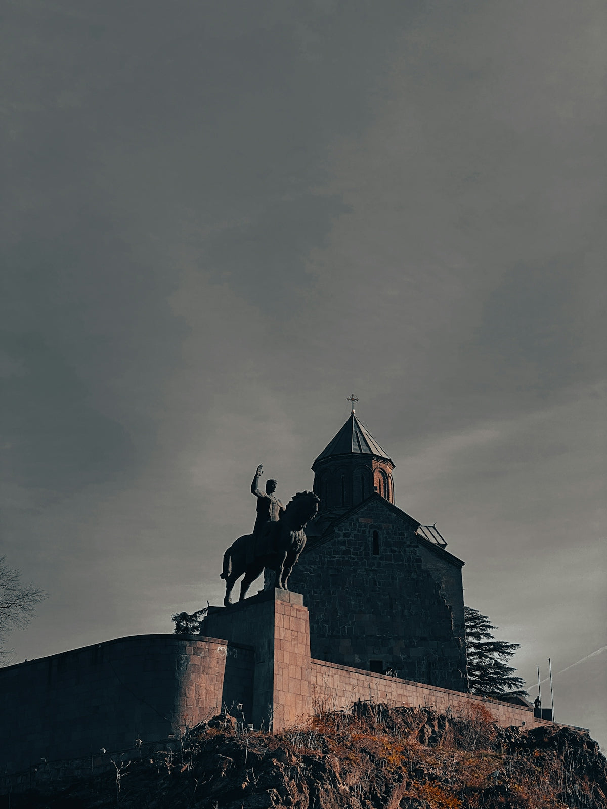A castle with a horse statue on top of it
