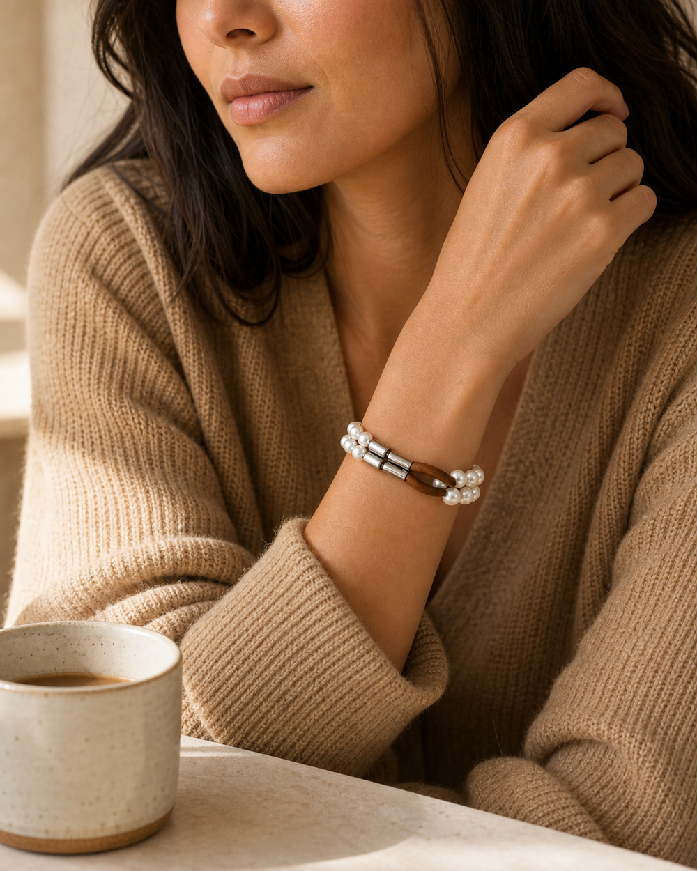 Cafe lifestyle wrist portrait of The Cognac Pearl Bracelet