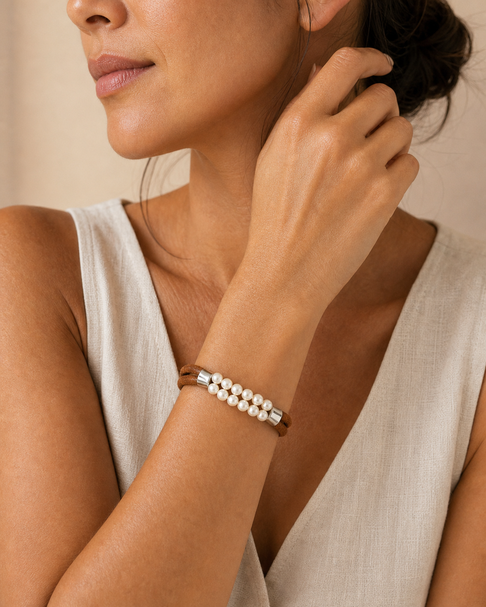 Close-up wrist portrait of a woman wearing The Cognac Pearl Bracelet
