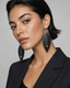 The Noir Leaf Earrings worn by a model in a studio portrait