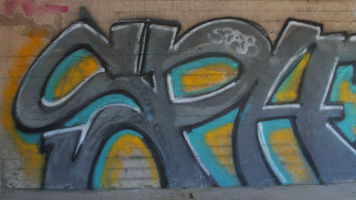 a wall with some graffiti on it