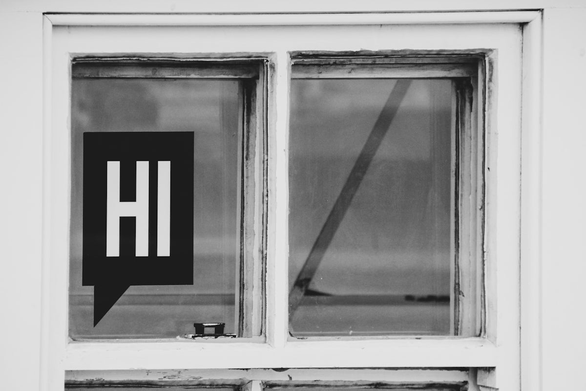 a black and white photo of a sign in a window