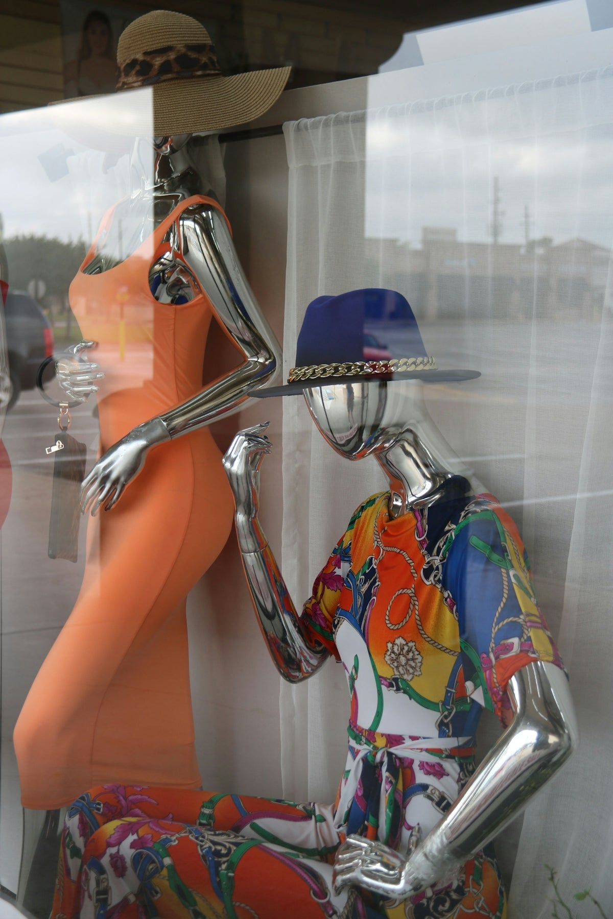 a mannequin in a window with a hat on it's head