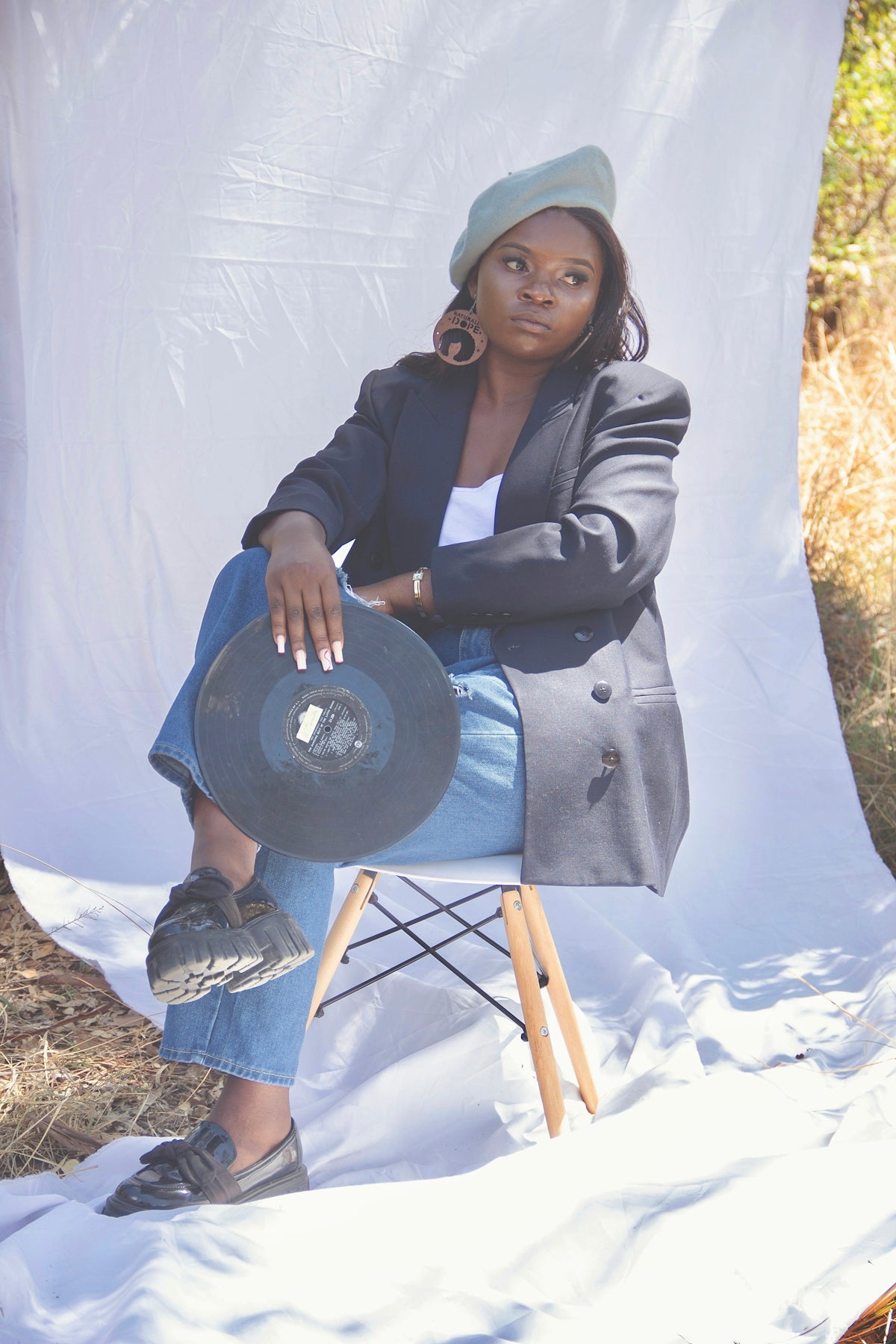 a woman sitting in a chair with a hat on her head
