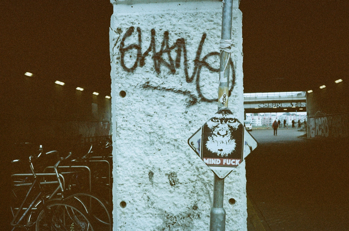 Graffiti and street art decorate a tunnel entrance.