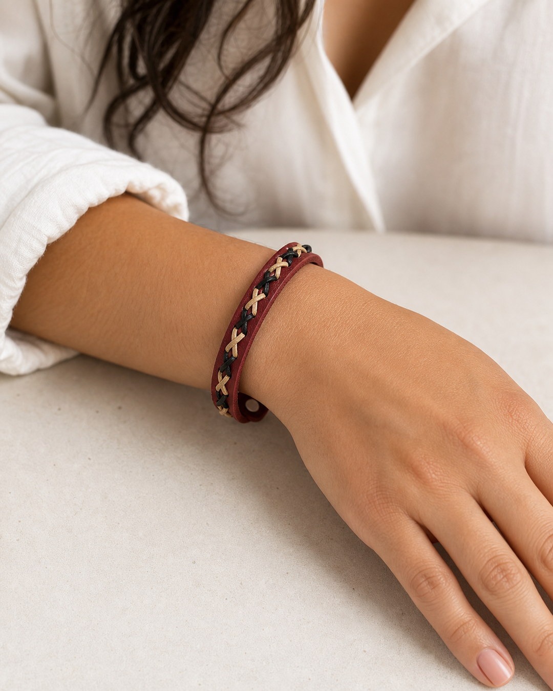 Crimson burgundy leather cuff bracelet with black and beige braided lacing on female model - view 3