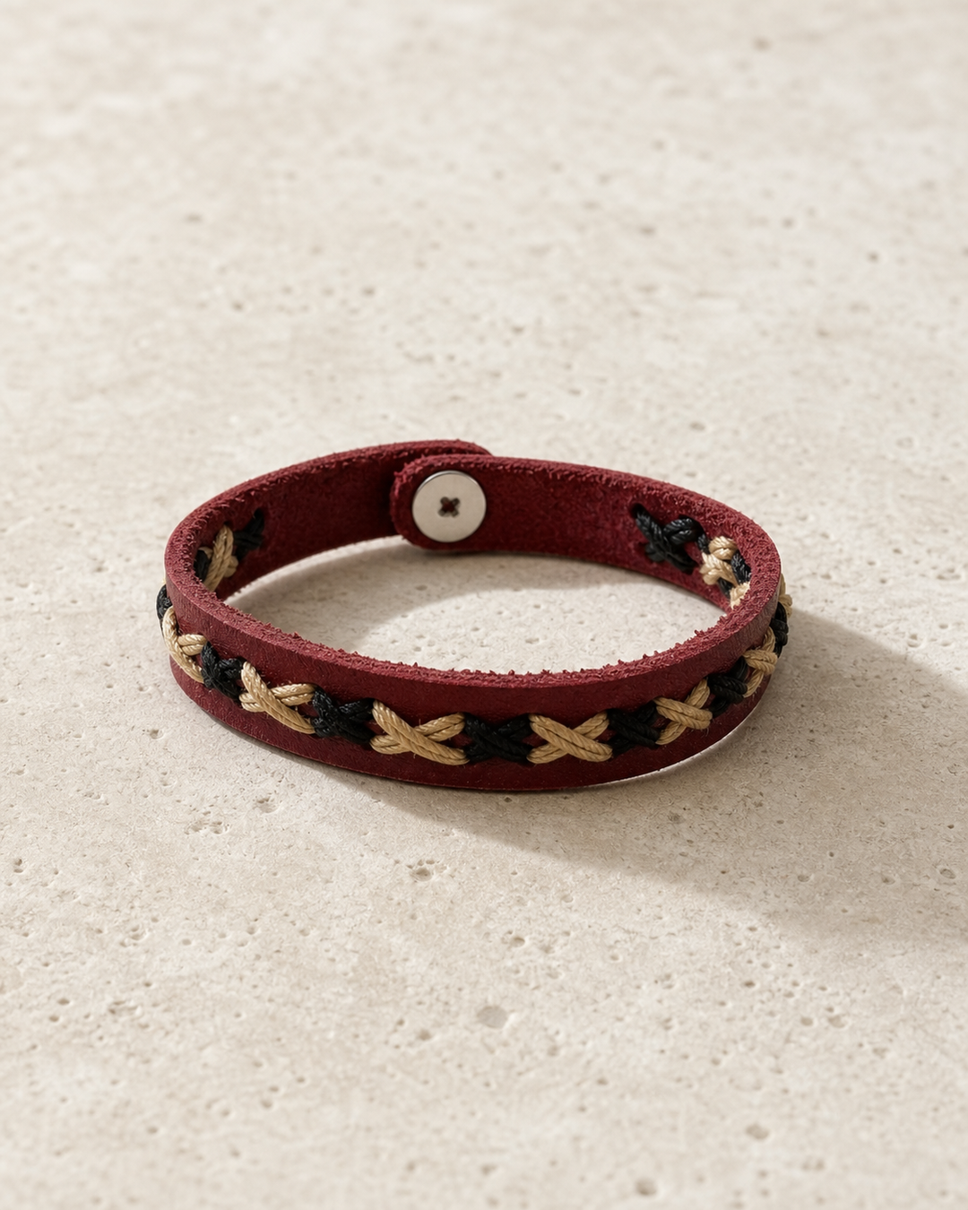 Crimson burgundy leather cuff bracelet with black and beige braided lacing on female model - view 5