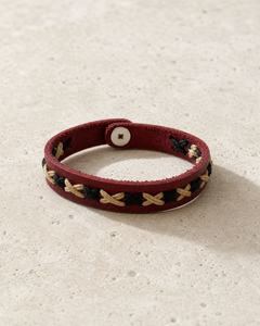 Crimson burgundy leather cuff bracelet with black and beige braided lacing on female model - view 5