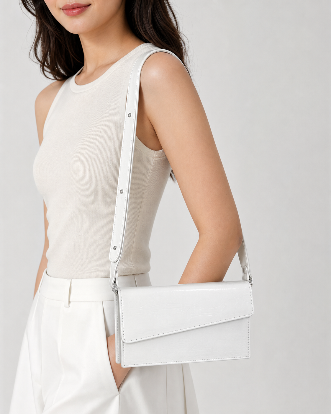 Ivora white glossy rectangular flap shoulder bag on female model - view 1