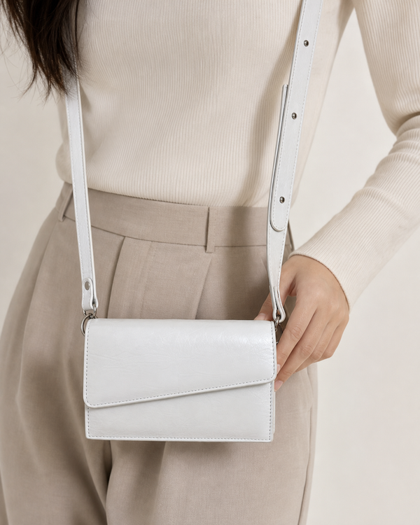 Ivora white glossy rectangular flap shoulder bag on female model - view 3