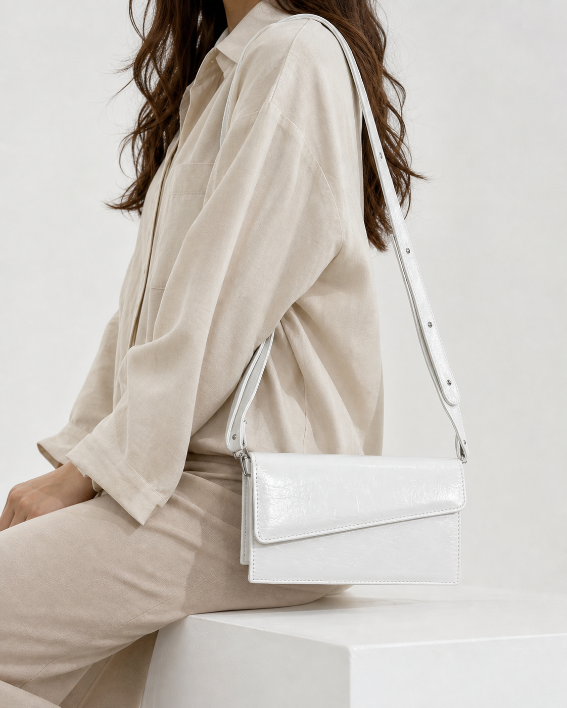 Ivora white glossy rectangular flap shoulder bag on female model - view 4