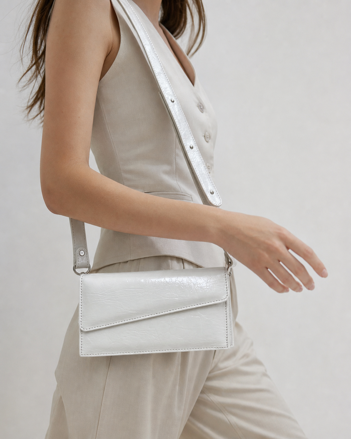 Ivora white glossy rectangular flap shoulder bag on female model - view 5