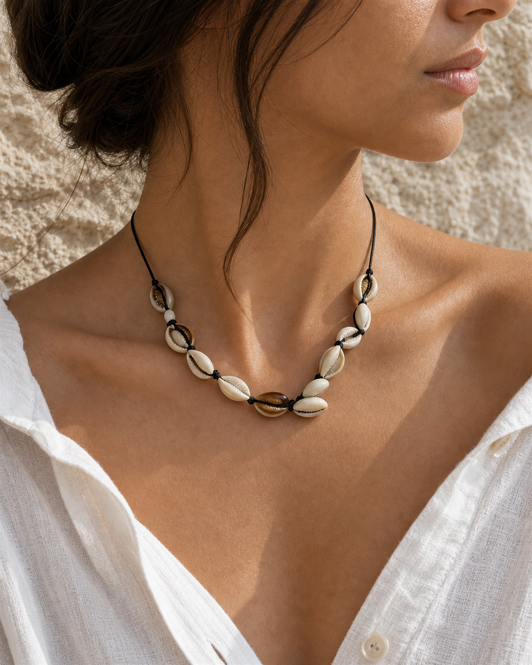 Marisca cowrie shell necklace on black cord on female model - view 2