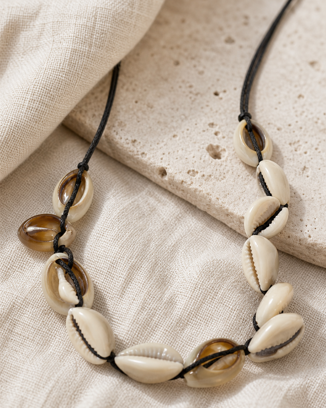 Marisca cowrie shell necklace on black cord on female model - view 4