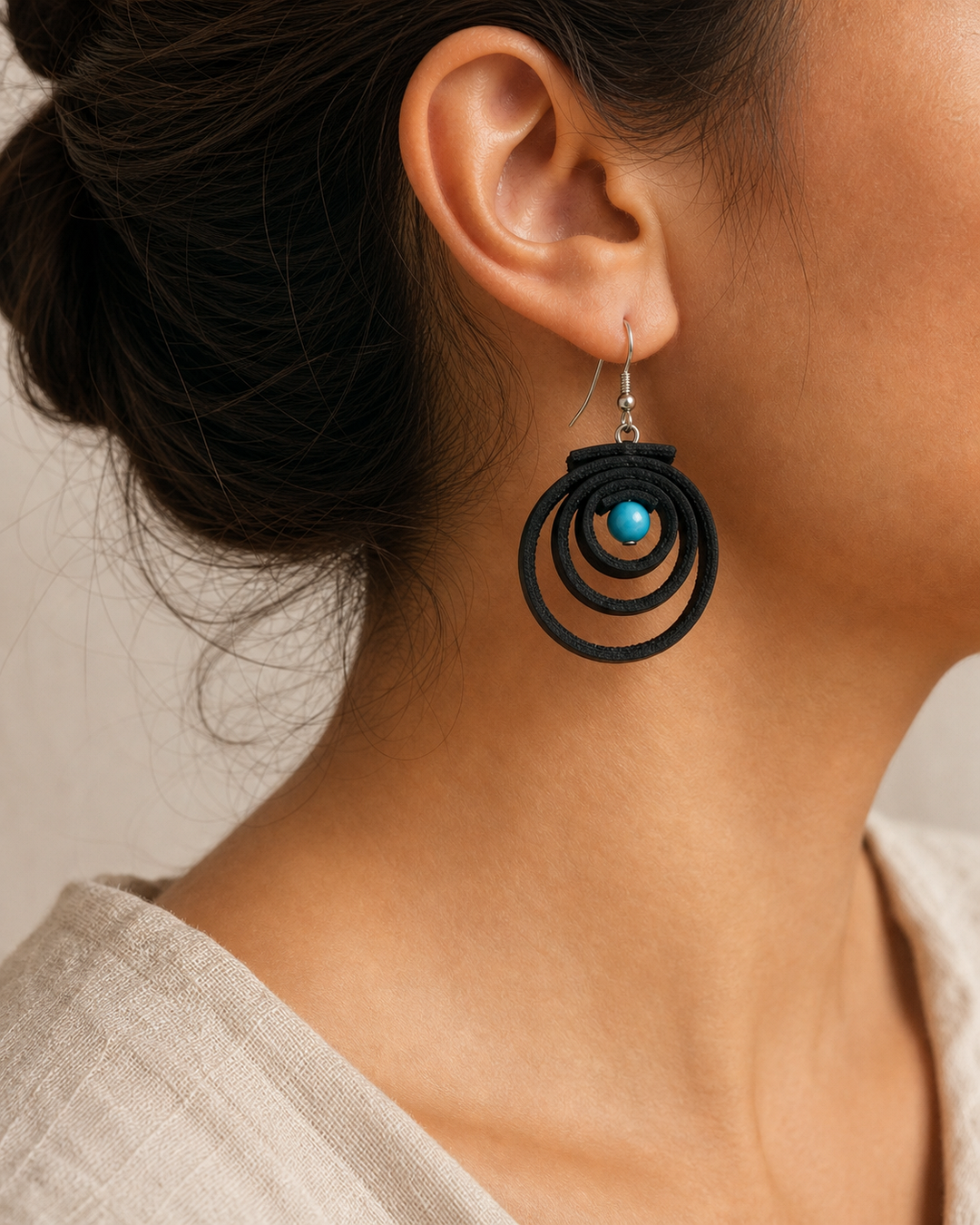 Noir Tide black spiral drop earrings with silver hook and turquoise blue bead - view 1