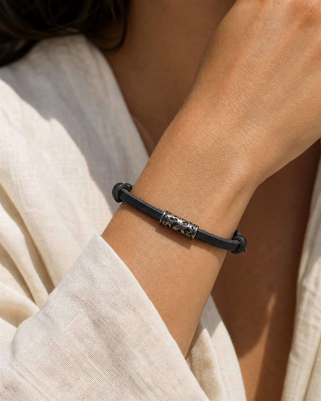 Ravelle black leather cord bracelet with silver tube charm on female model - view 1