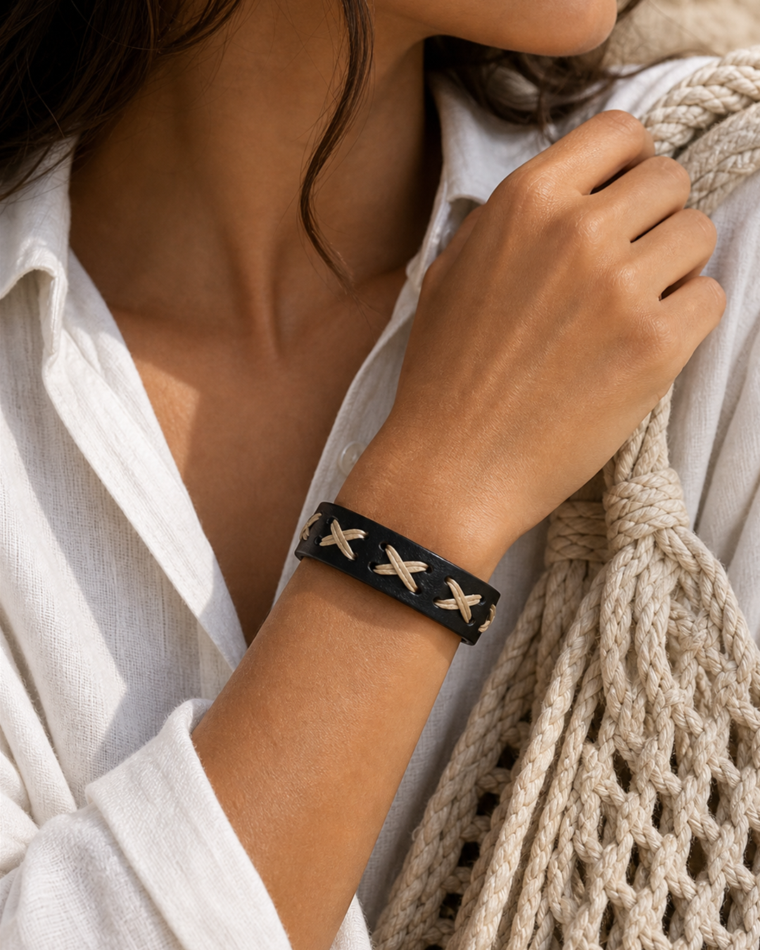 Serrin black leather cuff bracelet with cream X-stitch lacing on female model - view 2