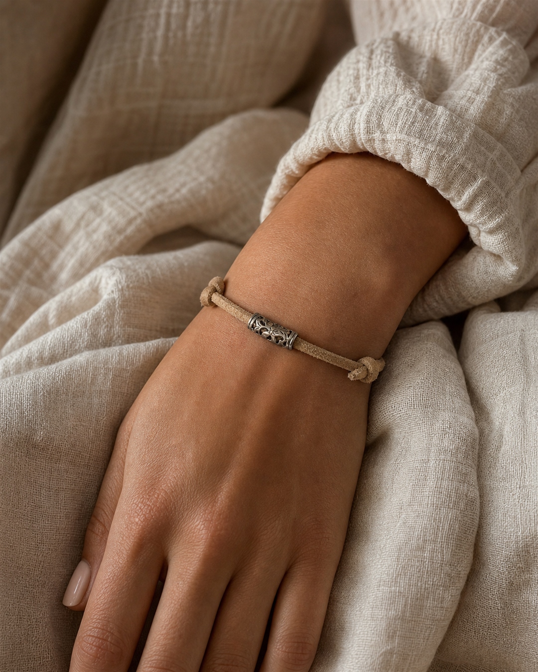 Tavira tan leather cord bracelet with silver tube charm on female model - view 1