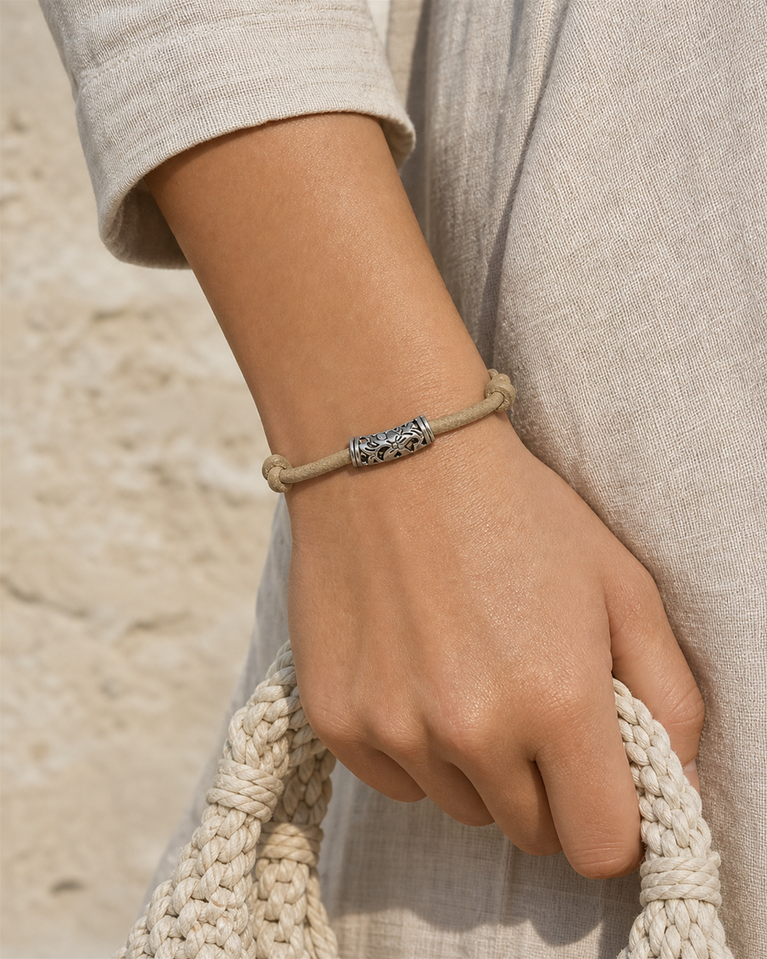 Tavira tan leather cord bracelet with silver tube charm on female model - view 2