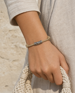 Tavira tan leather cord bracelet with silver tube charm on female model - view 2