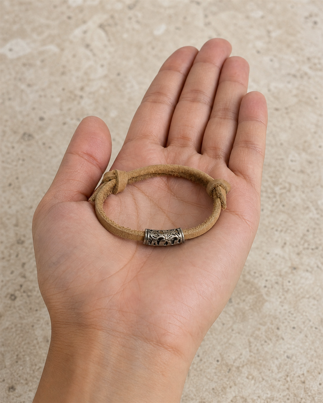 Tavira tan leather cord bracelet with silver tube charm on female model - view 3