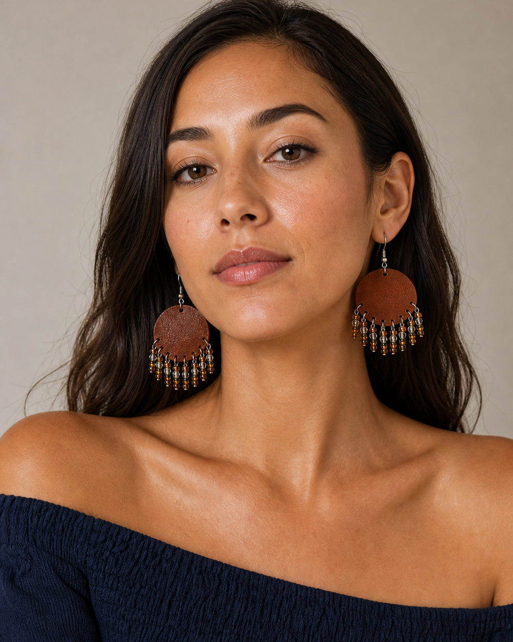 The Cognac Fringe Earrings worn by a woman in a true 4:5 front portrait