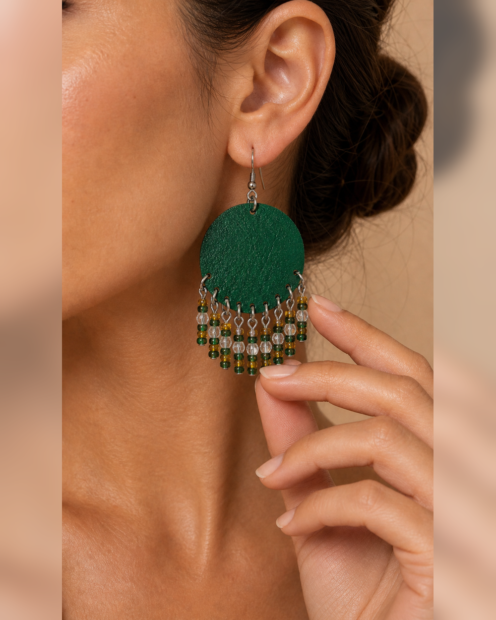 Close-up detail of The Emerald Fringe Earrings on a woman