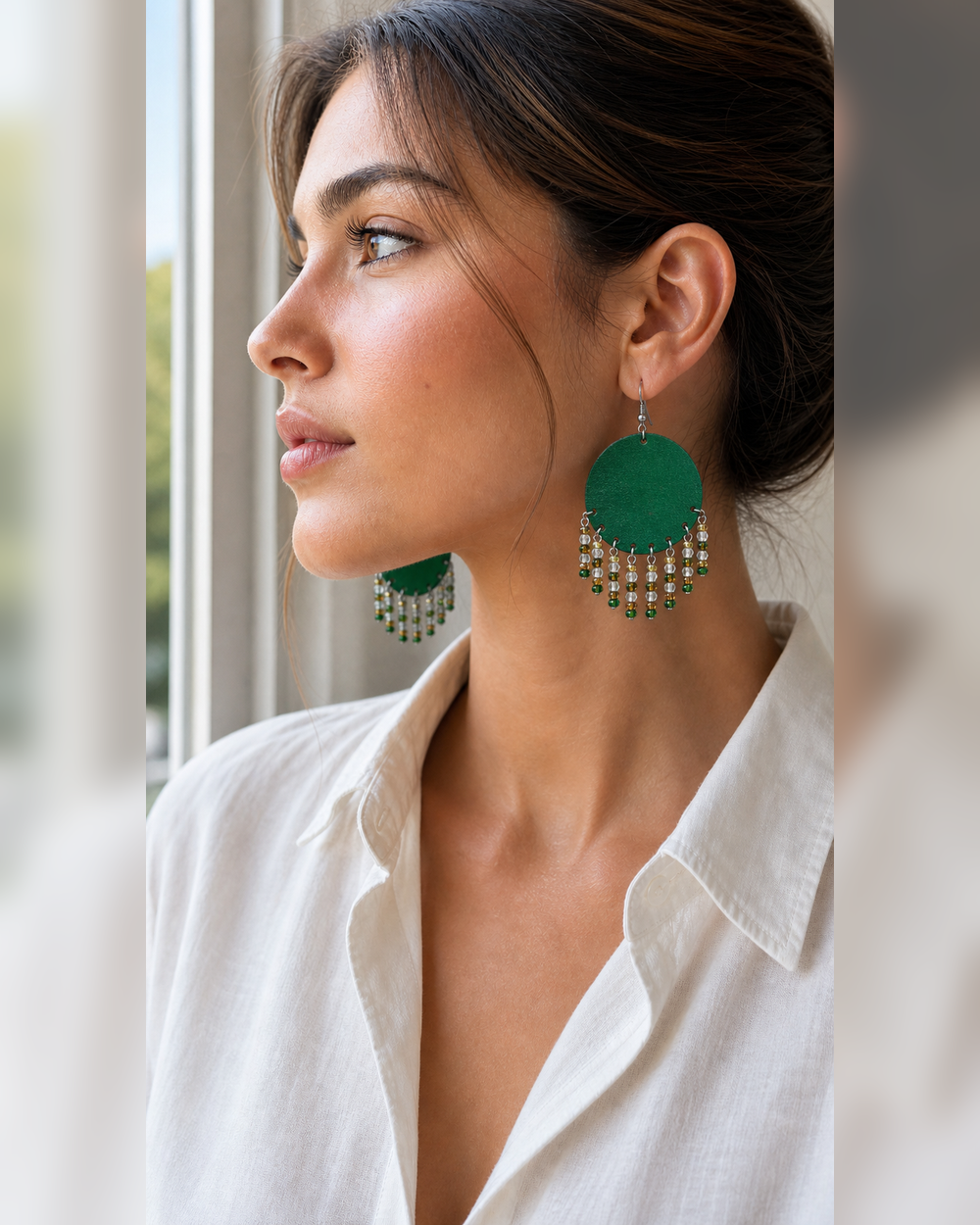 Side profile of a woman wearing The Emerald Fringe Earrings