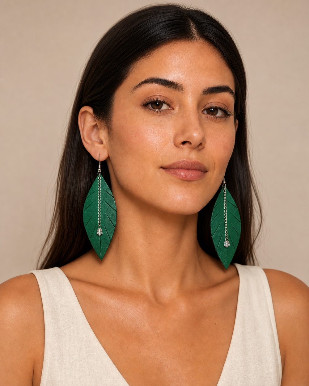 The Emerald Leaf Earrings worn by a model in a studio portrait