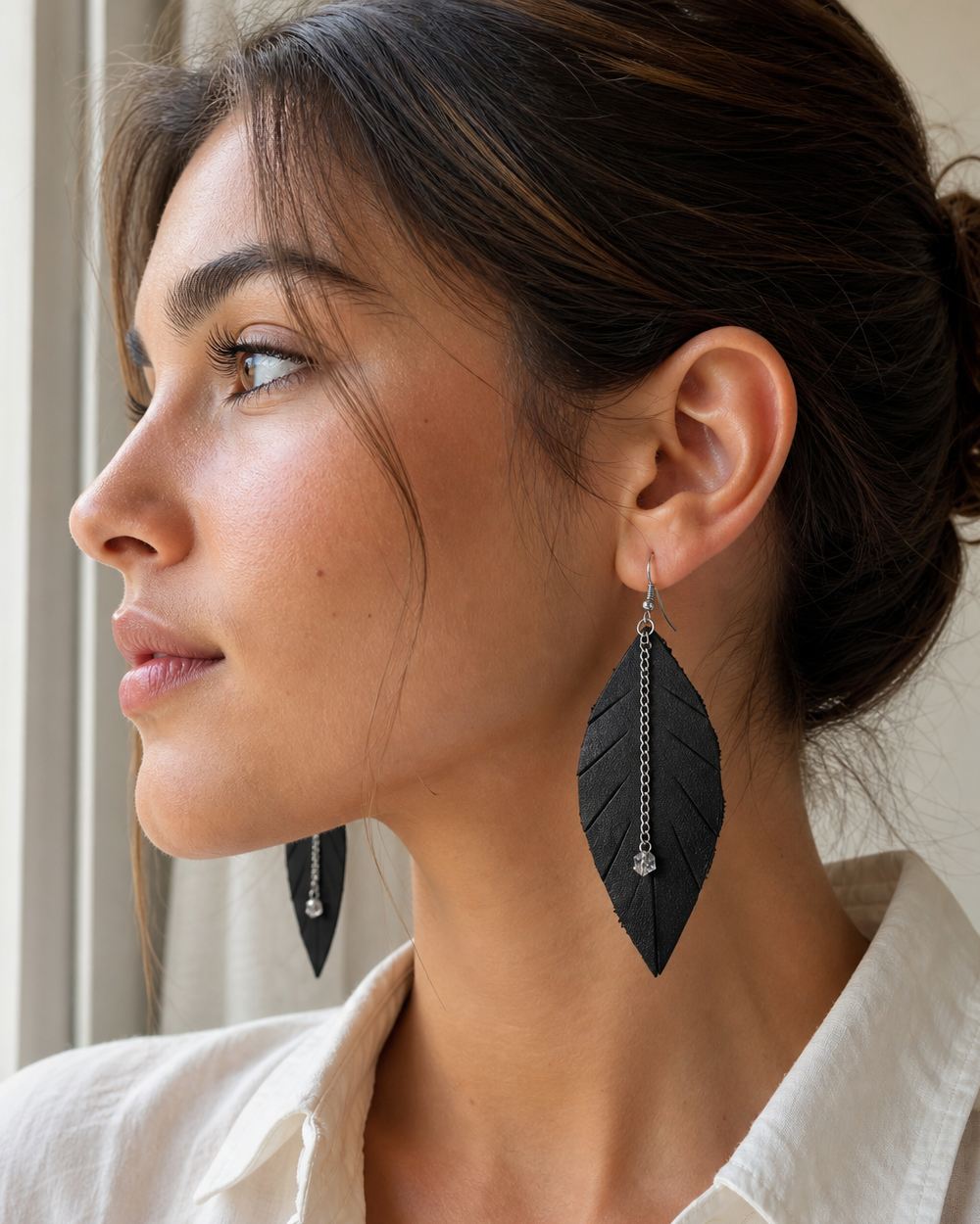 Side profile of model wearing The Noir Leaf Earrings