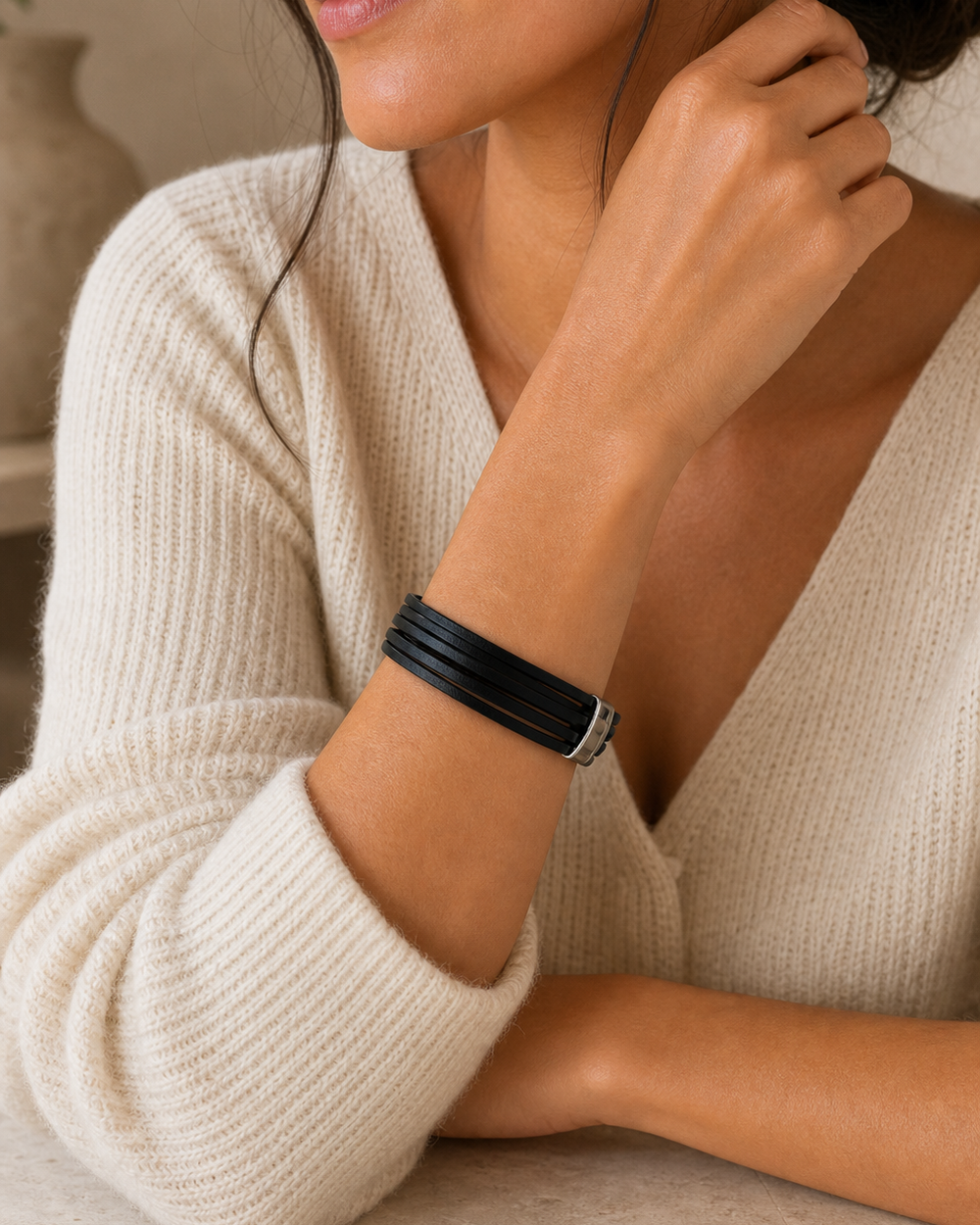 Cream sweater wrist portrait featuring The Noir Wrap Bracelet